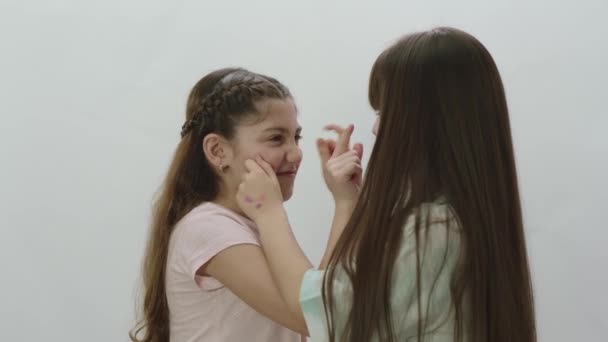Little Girlfriends Who Love Each Other Very Much Pinch Each — Stock Video