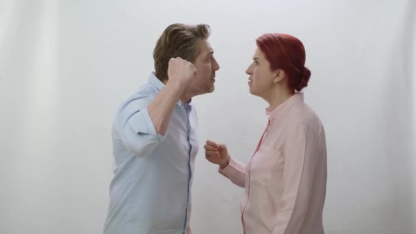 結婚生活に問題を抱えて戦う家族 男は妻を呼び 手を上げて殴ろうとしている 女性に対する暴力の概念 白い背景で口論する夫婦 — ストック動画
