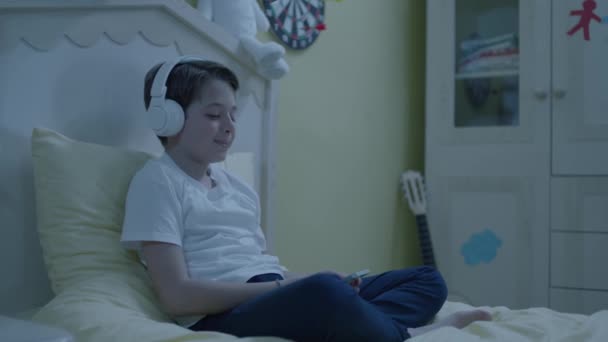 Little Boy Listening Music Smartphone Headphones His Bed Child Listens — Stock Video