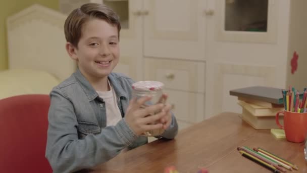 Learning Money His Parents Little Boy Leaves Coin His Piggy — Stock Video