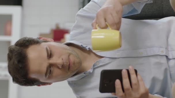 Thoughtful Young Man Using Smartphone Drinking Coffee Home Young User — Stock Video