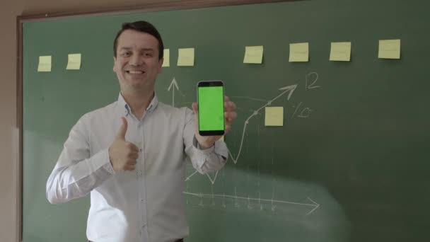 Male Teacher Front Blackboard Looking Information Phone Searching Something Internet — Vídeos de Stock
