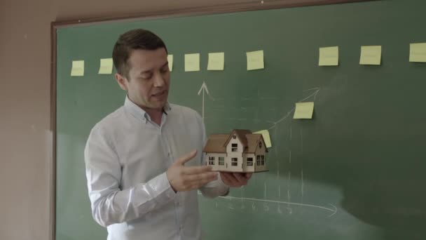 Male Real Estate Agent Explaining Model House Sales Team Front — Vídeos de Stock