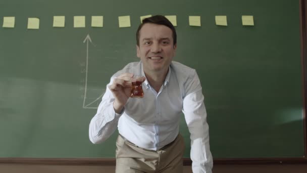 Male Teacher Drinking Tea Coffee Standing Front Blackboard Pasted Notes — Video