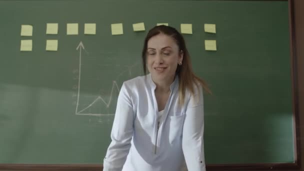 Female Teacher Standing Front Blackboard Pasted Notes Chalk Drawn Math — Stockvideo