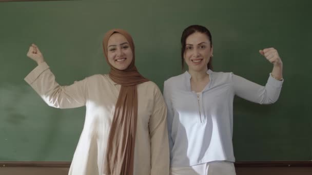 Female Teacher Hijab Female Colleague Classroom Arms Folded Front Blackboard — Stockvideo