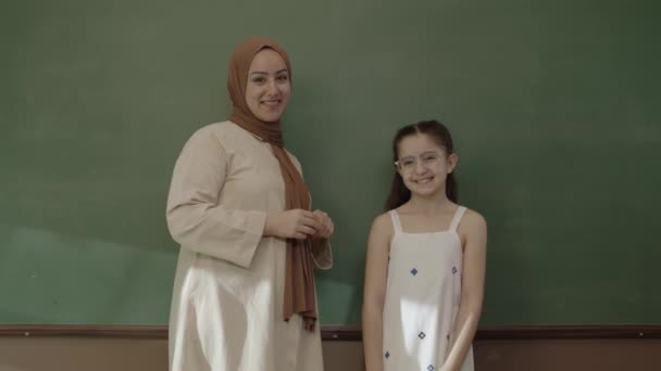 Little Schoolgirl Teacher Hijab Looking Camera Classroom Smiling Front Blackboard — Vídeo de Stock