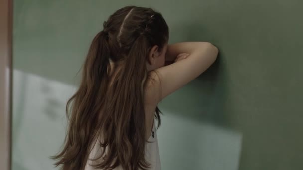 Little Sad Girl Standing Front Green Chalkboard Her School Little — Vídeo de stock