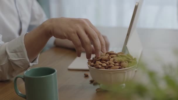 Freelance Man Drinking Coffee Eating Roasted Almonds Hazelnuts Cookies While — Video Stock