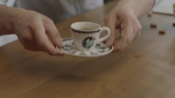 自宅で妻や友人にコーヒーを出す男 スローモーションで働く男 コーヒー休憩 トルコのコーヒーをゲストに提供しながら流出しないようにしようとしている男のクローズアップ手 — ストック動画
