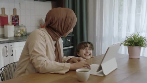 Young Hijab Mother Works Remotely Her Laptop Kitchen Little Girl — Stok Video