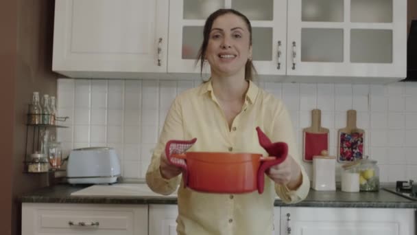 Young Mother Smells Food She Prepared Her Kitchen Puts Pot — Vídeo de Stock