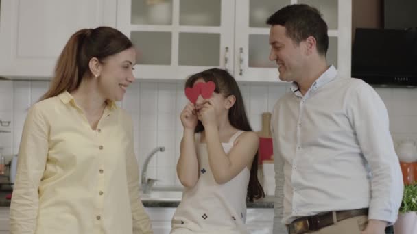 Little Girl Paper Hearts Her Eyes Having Fun Her Parents — Video Stock