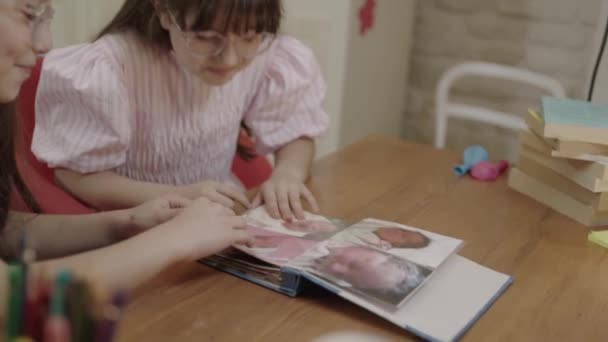 Happy Cute Little Girls Looking Photo Album Remembering Memories Laughing — Stockvideo