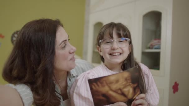 Little Girl Holding Image Her Unborn Siblings Ultrasound Girl Takes — Vídeo de Stock