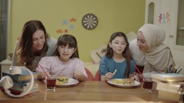 Moms Bringing Burgers Eat Little Girls Doing Schoolwork Veiled Mother — Video