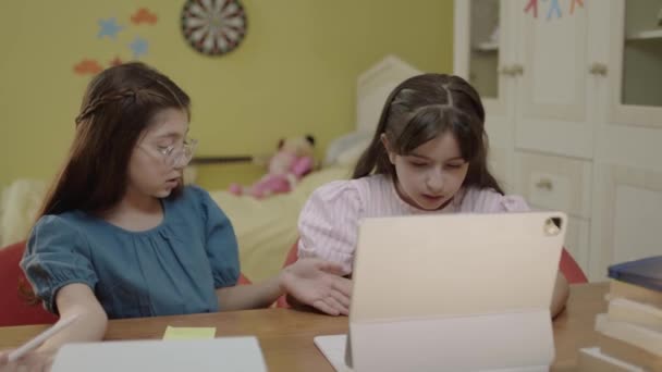 小さな女の子の学校の学生は自宅からオンラインで勉強したり ビデオ通話で教師に耳を傾けます 子供の距離教育 女子高生はノートパソコンを使ってオンライン学習を行う — ストック動画