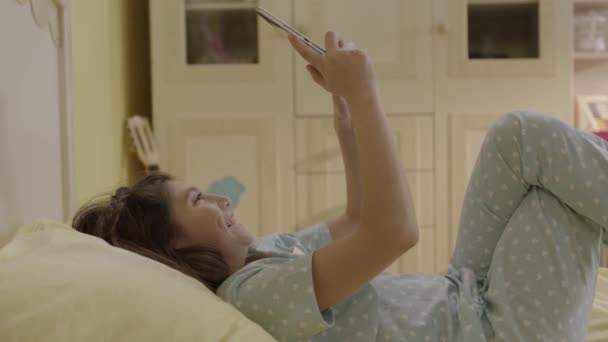 Little Girl Surfing Internet Tablet Computer Lying Her Bed Home — Stockvideo