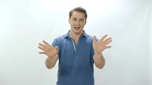 Character portrait of a man reacting, waving his hands saying No to a situation or person. A man isolated on a white background who wants his situation to end.