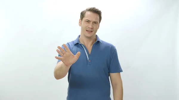 Character portrait of a man reacting, waving his hands saying No to a situation or person. A man isolated on a white background who wants his situation to end.
