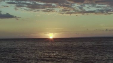 At sunset, the sun sets behind the sea.Winter landscape.Slow motion video.