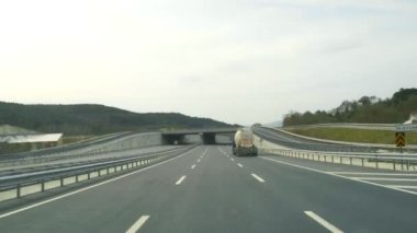 The car is driving on an asphalt road. Interior view of a car.