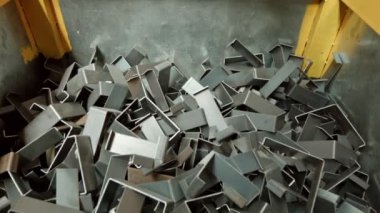 Iron profiles lined up in a factory producing metal profiles.Iron pieces are discarded.