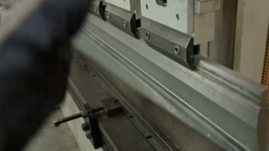 Iron cutting machine in a profile factory.A factory producing iron profiles. Profile material production machine in a modern plant. Factory assembly line line, automatic machine.