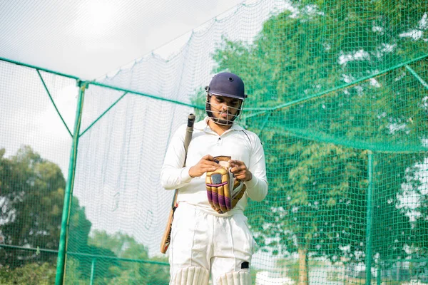 cricket player wearing hand gloves, ready to make a decisive move in the nets. The focus of the image is on the players gloves hand. The gloves offer excellent protection and enhanced grip.