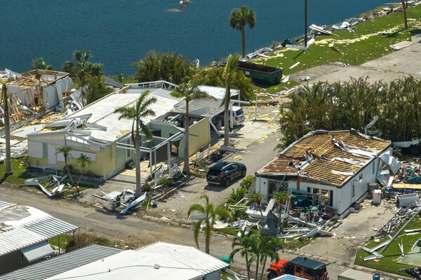 Badly damaged mobile homes after hurricane Ian in Florida residential area. Consequences of natural disaster.