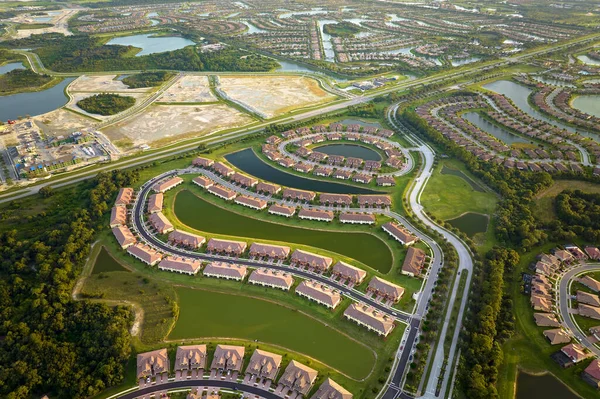 Real estate development with tightly located family houses under construction in Florida suburban area. Concept of growing american suburbs.