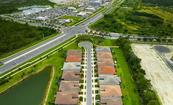 Aerial view of real estate development with tightly located family houses under construction in Florida closed suburban area. Concept of growing american suburbs.
