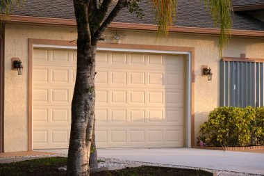 Wide garage double door and concrete driveway of new modern american house.