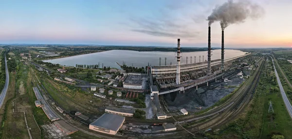 Stock image Aerial view of coal power plant high pipes with black smoke moving upwards polluting atmosphere at sunset. Production of electrical energy with fossil fuel concept.