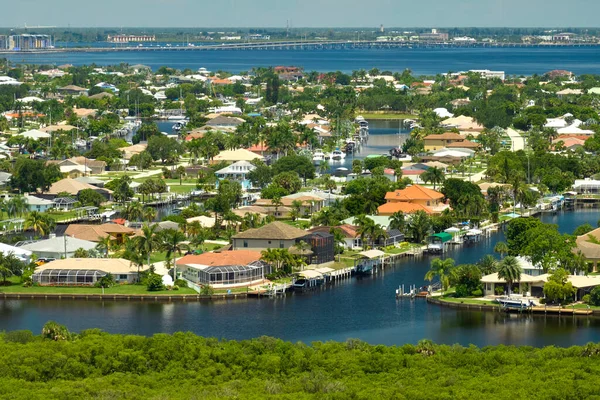 stock image Aerial view of residential suburbs with private homes located on gulf coast near wildlife wetlands with green vegetation on sea shore. Living close to nature concept.