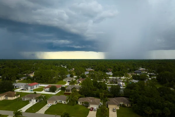 stock image Landscape of dark ominous clouds forming on stormy sky during heavy thunderstorm over rural town area.