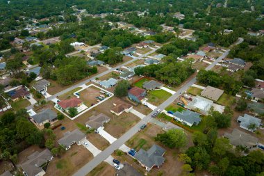 Florida kırsal kesimindeki yeşil palmiye ağaçları arasındaki banliyö özel evlerinin hava manzarası.