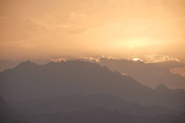 Sunset landscape with dark mountain peaks in egyptian desert.