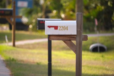 Typical american outdoors mail box on suburban street side.