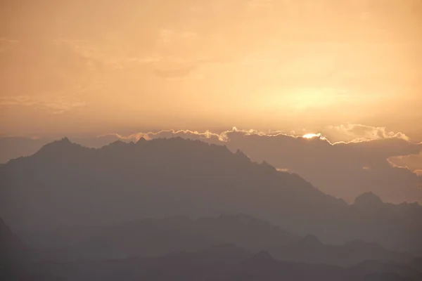 Stock image Sunset landscape with dark mountain peaks in egyptian desert.