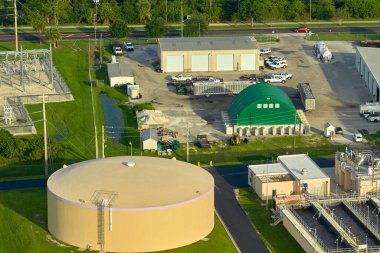 Aerial view of modern water cleaning facility at urban wastewater treatment plant. Purification process of removing undesirable chemicals, suspended solids and gases from contaminated liquid.