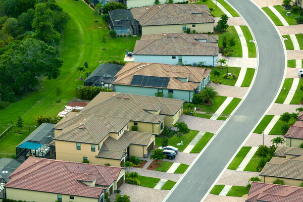 Aerial view of tightly packed homes in Florida closed living clubs. Family houses as example of real estate development in american suburbs.
