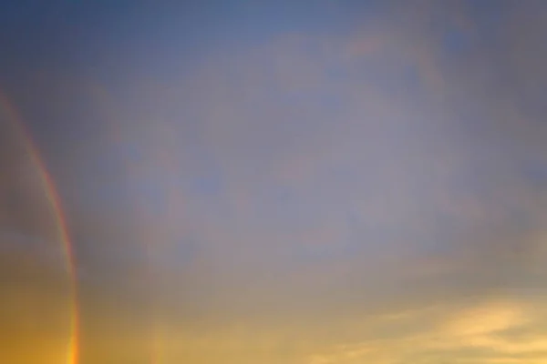 stock image Colorful round rainbow against blue evening sky after heavy thunderstorm.