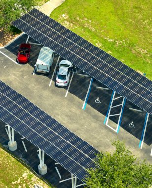 Solar panels installed over parking lot for parked cars for effective generation of clean energy. clipart