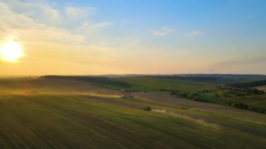 Aerial view of combine harvesters working during harvesting season on large ripe wheat field. Agriculture concept.