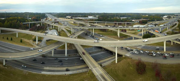 stock image Aerial view of american freeway intersection with fast moving cars and trucks. USA transportation infrastructure concept.