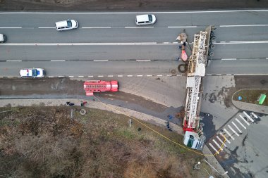 Aerial view of road accident with overturned truck blocking traffic. clipart