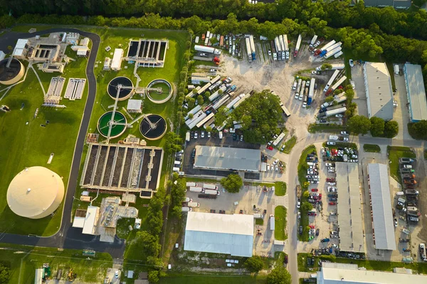 Aerial view of modern water cleaning facility at urban wastewater treatment plant. Purification process of removing undesirable chemicals, suspended solids and gases from contaminated liquid.