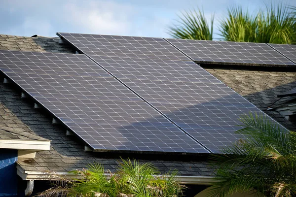 Private home roof covered with solar photovoltaic panels for generating of clean ecological electric energy in suburban rural town area. Concept of autonomous house.