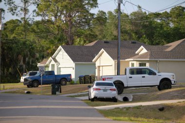 Geniş garajın önüne park edilmiş bir araba. Yeni modern Amerikan evinin beton yolu üzerinde çift kapı..